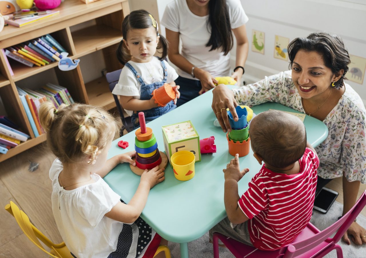 nursery-children-playing-with-teacher-in-the-classroom